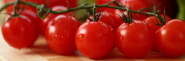 Cherry tomatoes lie on a cutting board