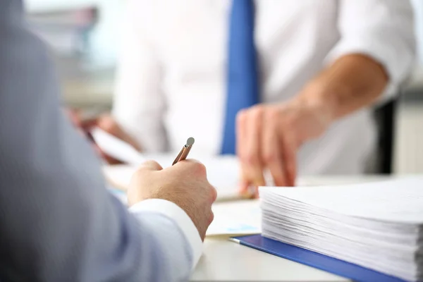 Clerk man at office workplace with silver pen in arms Stock Image