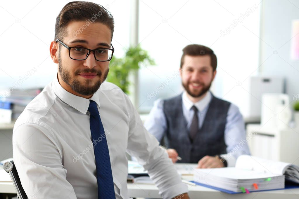 Group of smiling bearded businessmen in suit and tie