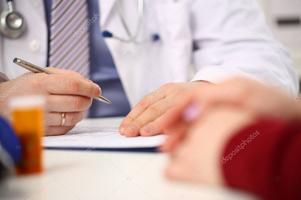 Male doctor hand hold silver pen filling