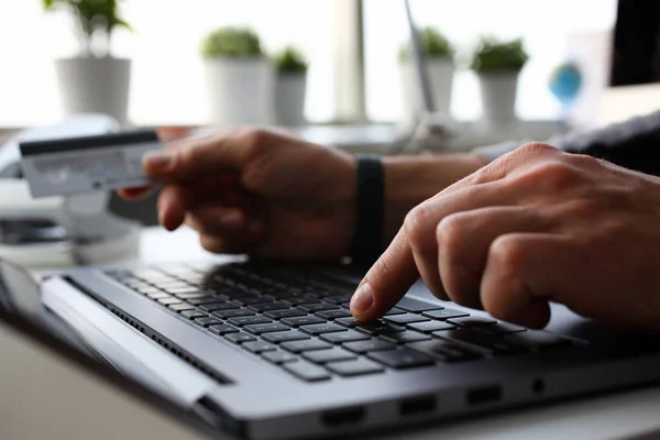 Male arms hold credit card press buttons — Stock Photo, Image