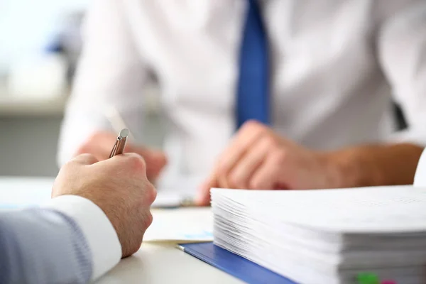 Sachbearbeiter am Büroarbeitsplatz mit silbernem Stift im Arm — Stockfoto