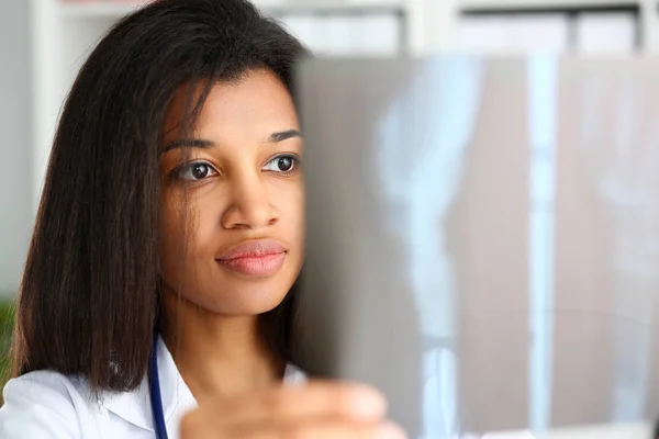 Female black doctor hold in arm and look