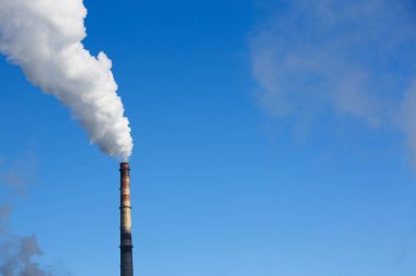 Beyaz duman boruları mavi gökyüzü karşı gelir