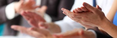 Bir grup insan seminer sırasında satır kollarını çırp