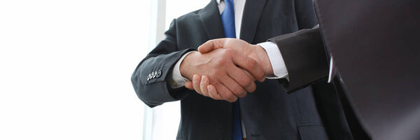 Man in suit shake hand as hello in office