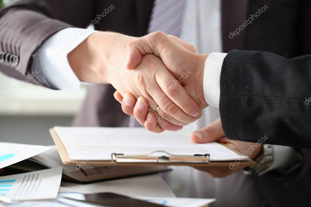 Man in suit shake hand as hello in office