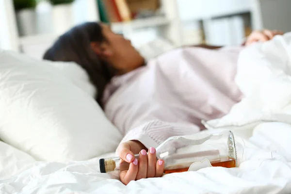 Young woman lying in bed deadly drunken — Stock Photo, Image