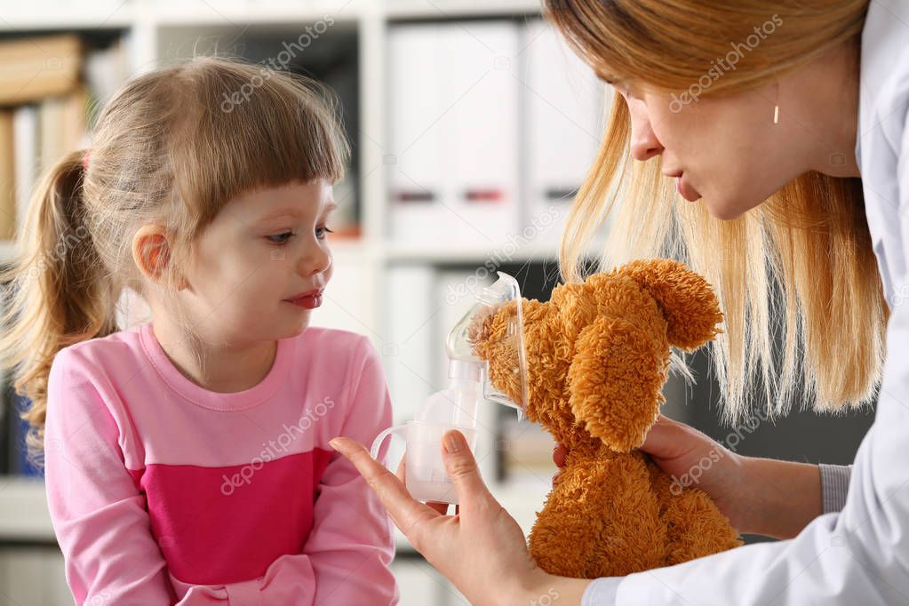 Doctor play with little patient giving inhaler to toy