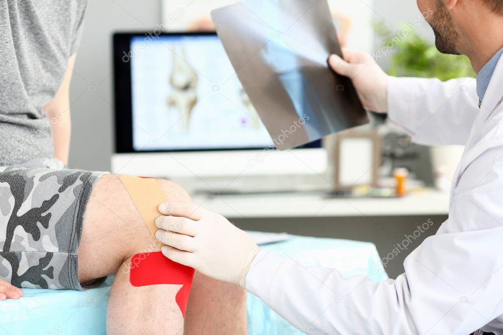 Doctor with patient holding xray shot prescribing treatment