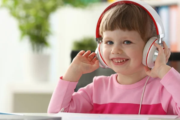 Little girl wearing headphones use mobile computer — Stock Photo, Image