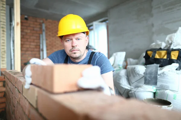 Concentrated man with brick — Stock Photo, Image