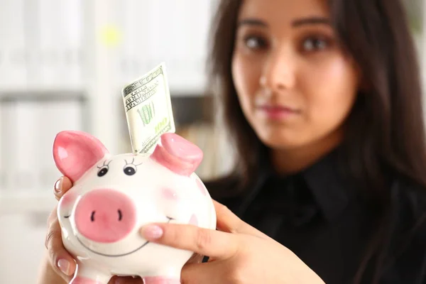 Woman hold piggybank in arms — Stock Photo, Image