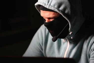 Man carder in mask connect to darknet clipart