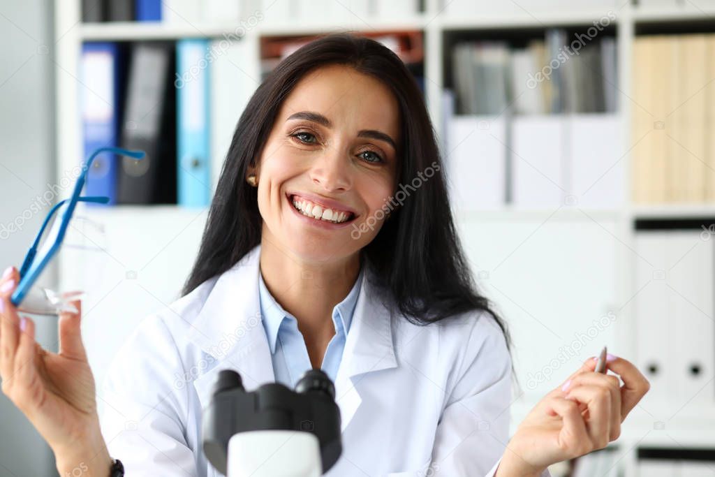 Beautiful female assistant sitting at worktable