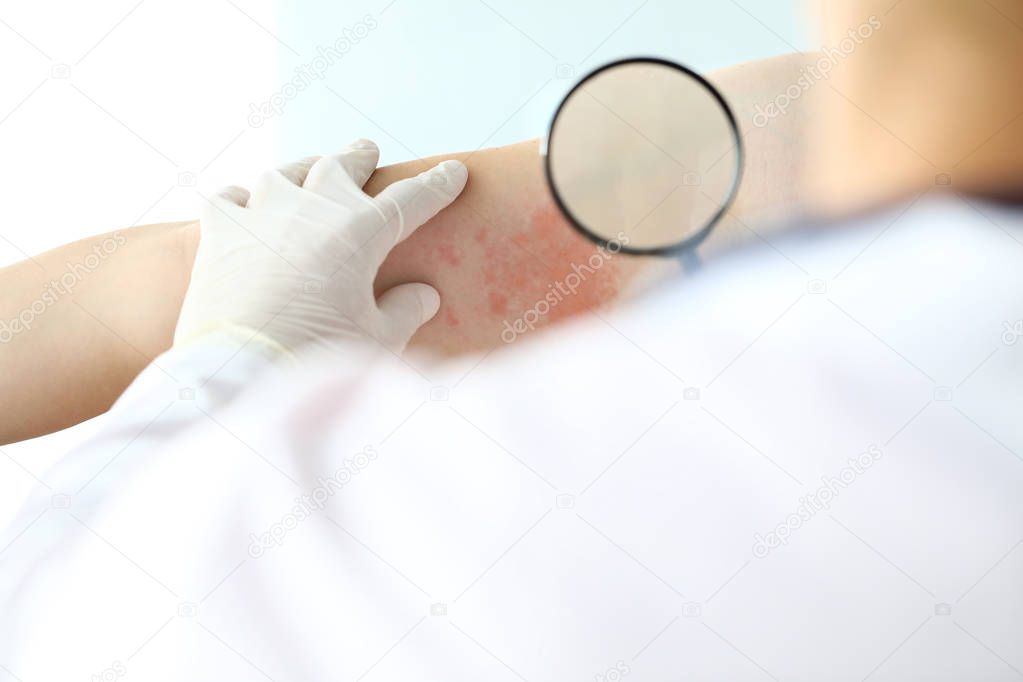 Gloved hands of professional dermatologist