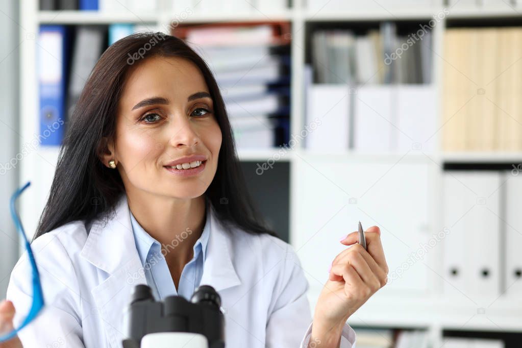 Beautiful female assistant sitting at worktable