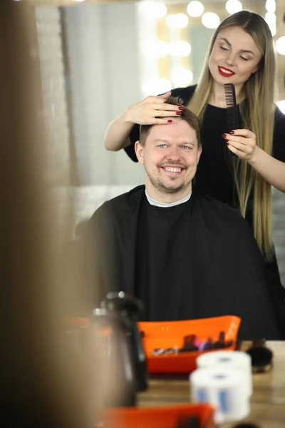 Woman Barber Making Haircut for Smiling Man Client