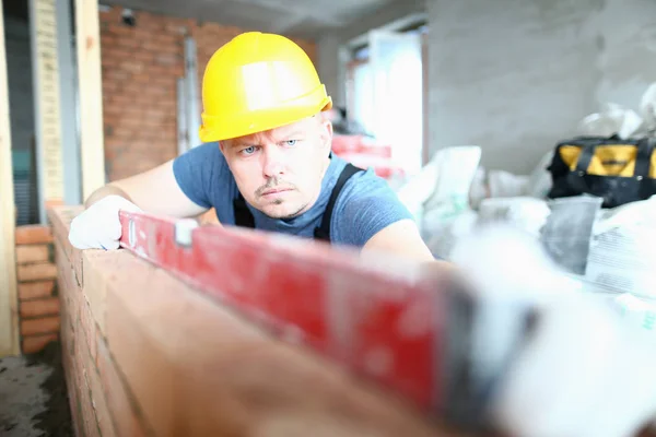 Thoughtful male holding tool — Stock Photo, Image