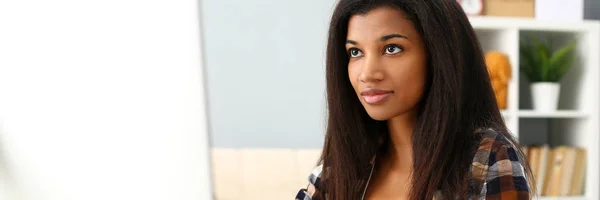 Preto sorrindo mulher sentado no local de trabalho trabalhando com desktop pc — Fotografia de Stock