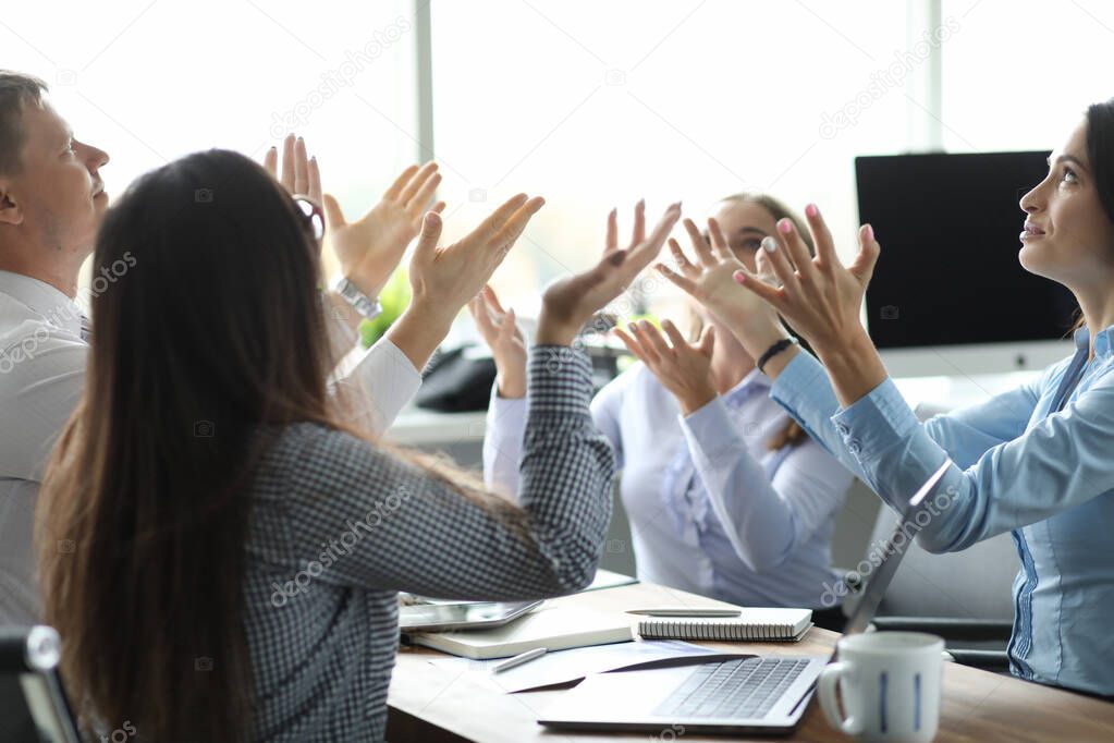 Team of business people raise hand from office background