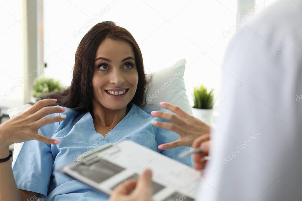Adult caucasian beautiful woman shows doctor
