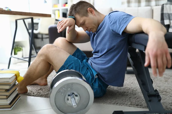 Cansado de los ejercicios deportivos chico se sienta en casa —  Fotos de Stock