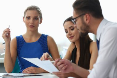 Güzel bir ofis çalışanı partnerlerinin yanında oturuyor.