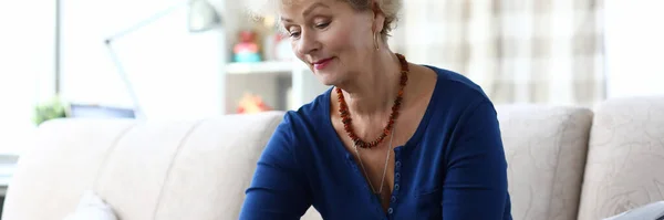 Woman holding credit card while sitting laptop