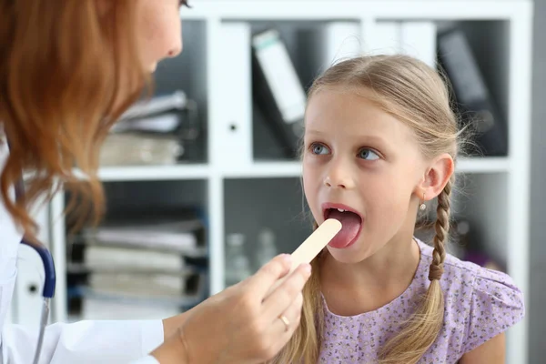 Enfant ayant un examen de la gorge avec un dépresseur de langue à l'hôpital — Photo