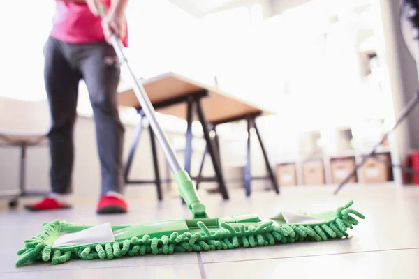 Woman doing water cleaning of floor in kitchen — Stock Photo, Image