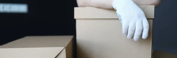 Gloved hands loader lie on cardboard boxes office — Stock Photo, Image