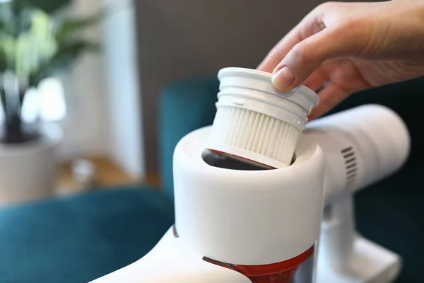 Female hand pull out white filter from white vacuum cleaner close up. — Stock Photo, Image