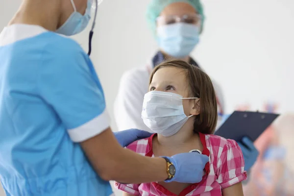 Lekarz słucha dziewczyny oddychającej stetoskopem w recepcji w klinice — Zdjęcie stockowe
