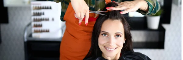 Female hairdresser cuts woman client portrait — Stock Photo, Image