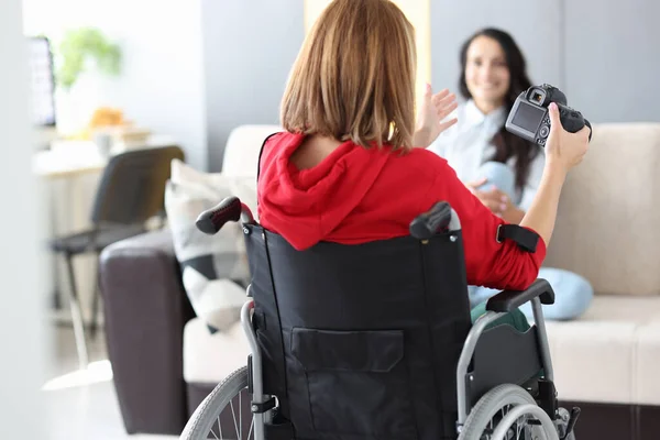 Інвалідна жінка в інвалідному візку фотографії дівчини в квартирі — стокове фото