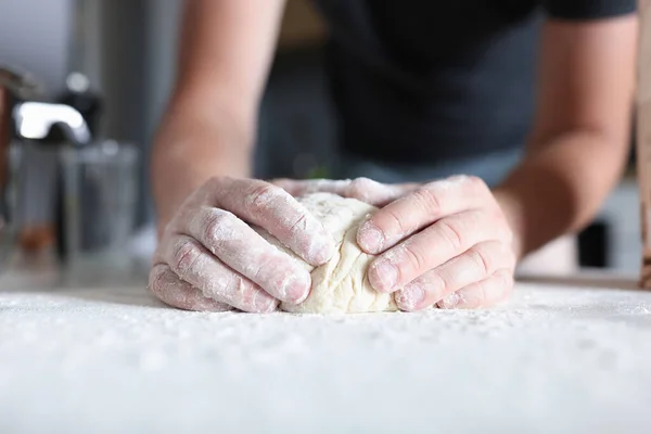 Male hands prepare dough in kitchen. — Stock Photo, Image