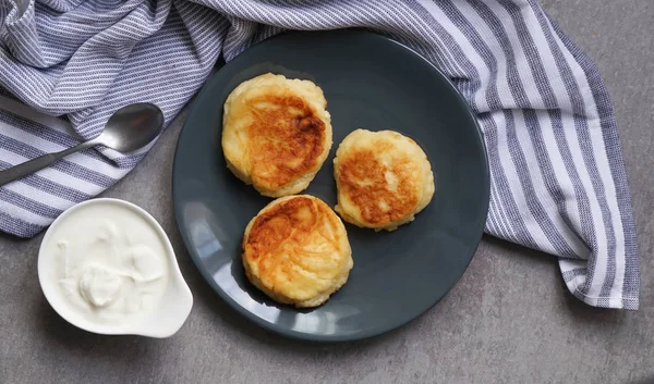 cottage cheese pancakes, tasty healthy breakfast, top view, grey stone background