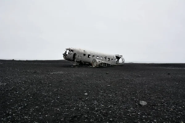 Abandoned Plane Wreck on a Desolate Black Sand Beach