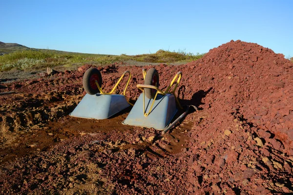 Blue Yellow Wheelbarrows Red Soil — Stock Photo, Image