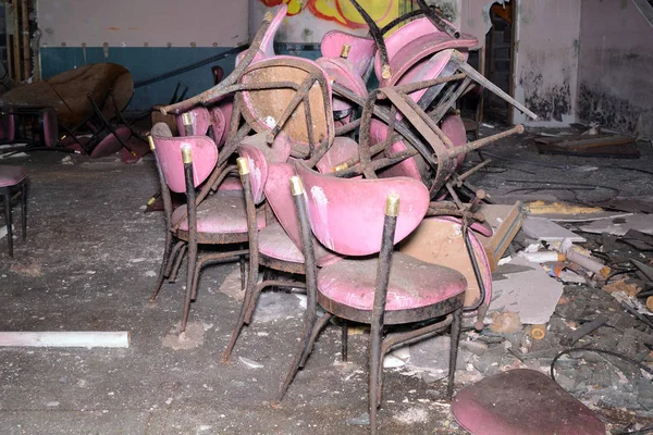 Pile of Chairs In an Abandoned Dining Hall