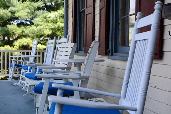White and Blue Wood Chairs on a Porch