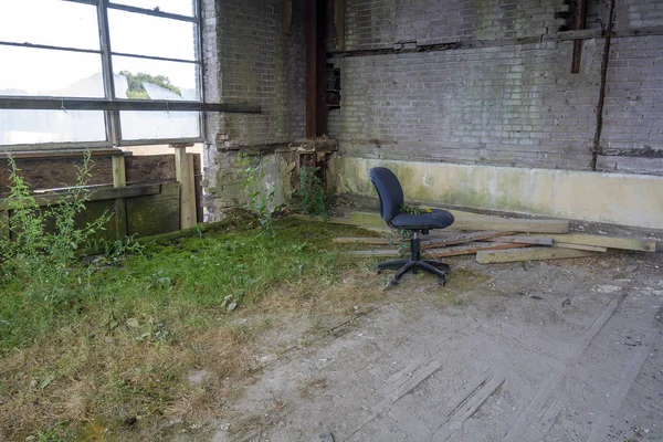 Office Chair in Empty Classroom of an Abandoned School Building