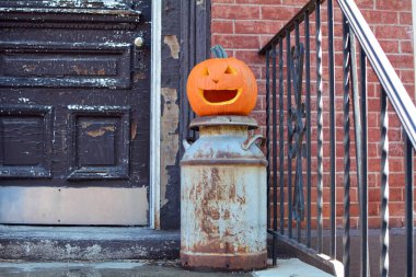 Carved Pumpkin - Jack o Lantern Halloween Decoration on Front Porch