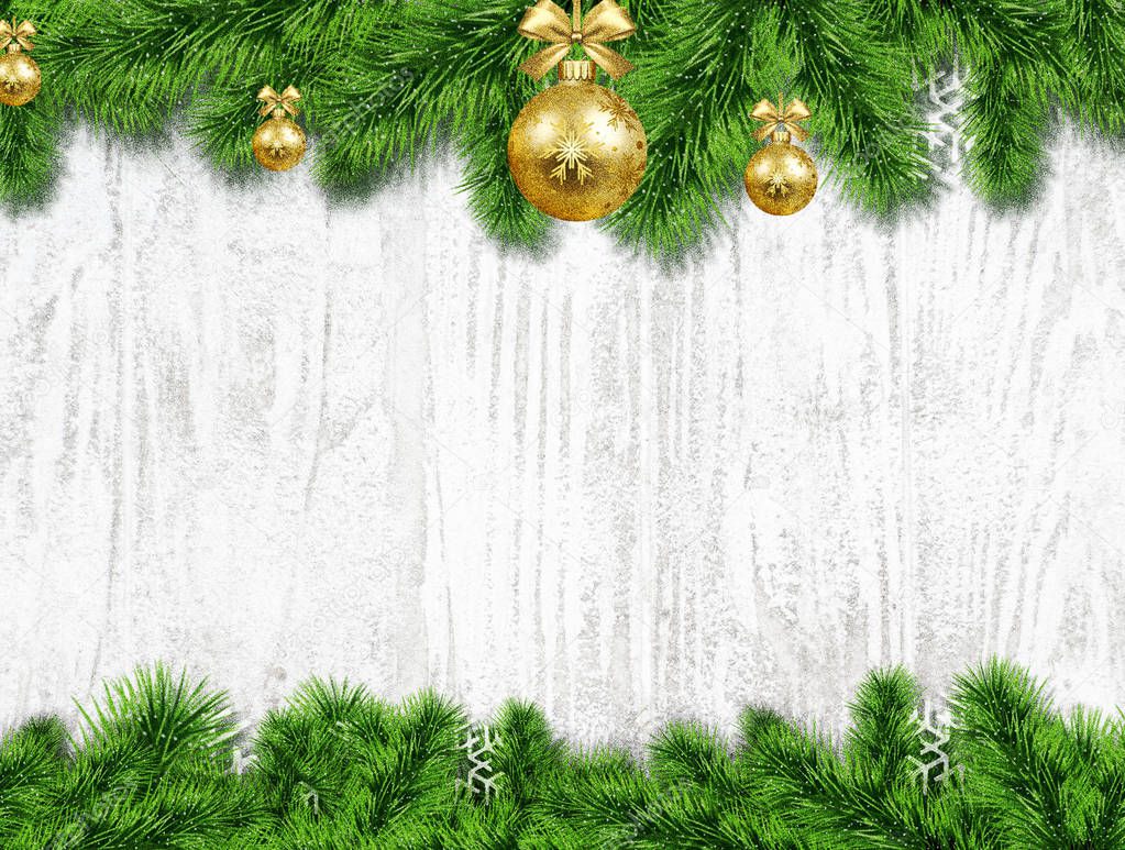 Decoration of spruce twigs with bubbles in the snow on a wooden white background.