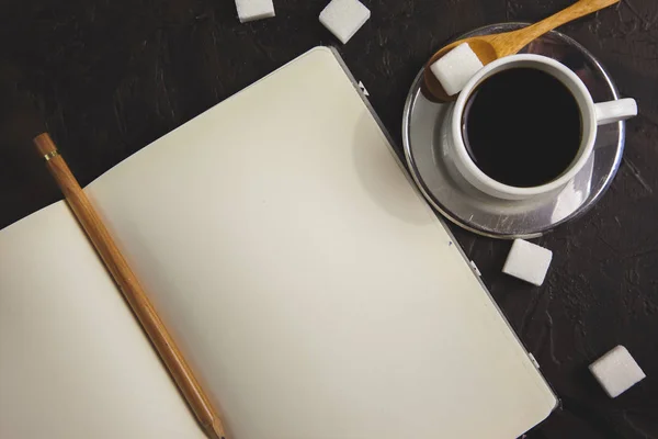 Coffee and ideas in a white notebook