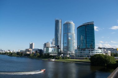 Yekaterinburg at sunset.city pond.boat competitions . clipart
