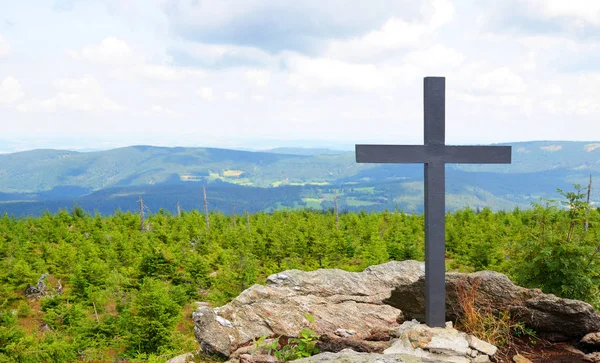 Cross on the mountain summit Svaroh in the national park Sumava, Czech Republic.