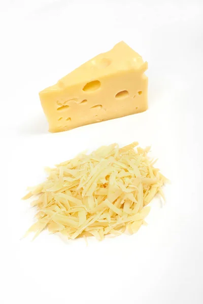 Piece of cheese and heap of grated cheese, isolated on white background. — Stock Photo, Image