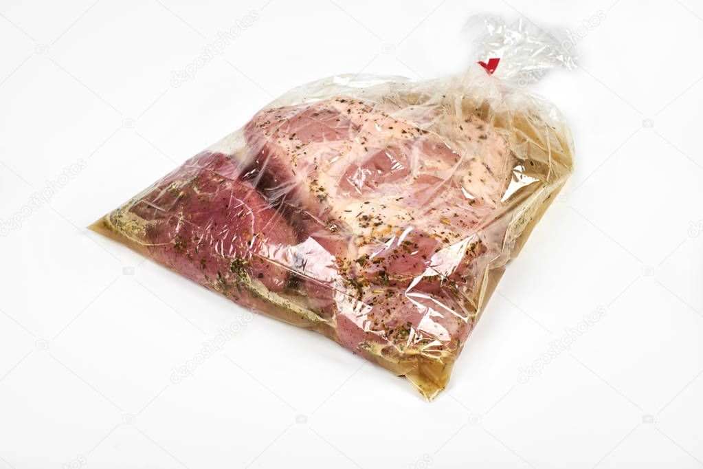 fresh meat packaged in a sleeve with spices, for baking is ready for baking, isolated on white background